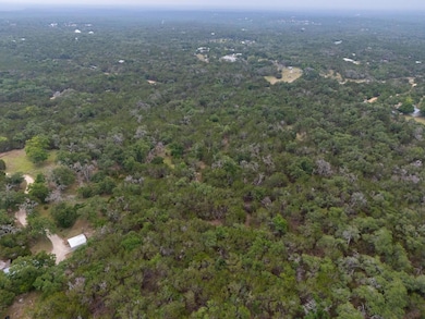 View of property location featuring a heavily woo