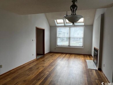 Interior space featuring vaulted ceiling with skyl