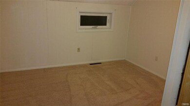 Upstairs bedroom with wall-to-wall carpet.