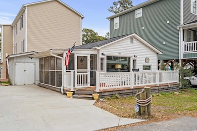 View of front of home with a sunroom and a deck
