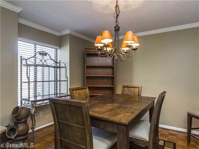 Dining Room. Gleaming woods floors, crown molding and a contemporary light fixture add a touch of grace in the dining room.
