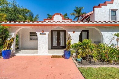 Doorway to property featuring covered porch, stucco siding, and a tile roof