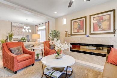 Carpeted living area featuring a tiled fireplace,