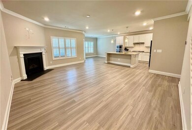 Unfurnished living room with baseboards, light woo