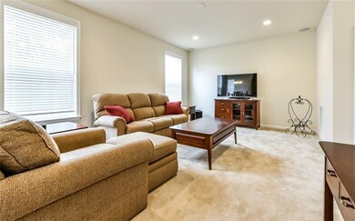 Spacious family room with two large windows, neutr