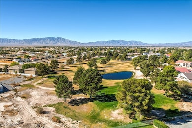 Aerial perspective of suburban area featuring a water and mountain view and a golf course