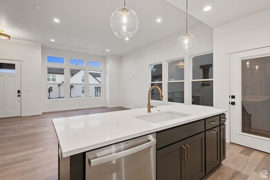 Gourmet Kitchen featuring tasteful backsplash, recessed lighting, white cabinets, light wood-style flooring, built in range, wood hood, and appliances with stainless steel finishes