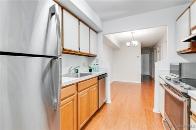 Kitchen with pendant lighting, sink, light hardwoo