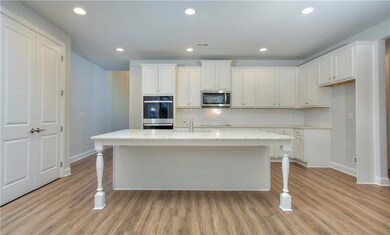 Kitchen with stainless steel appliances, baseboard