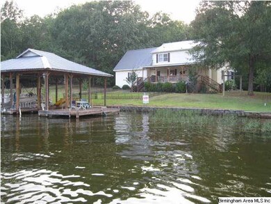 Lake view of home and boathouse. Note the beautifu