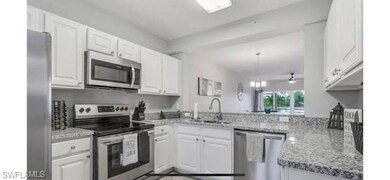 Kitchen featuring stainless steel appliances, a si