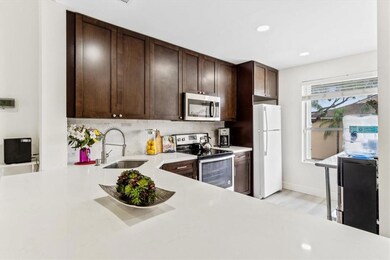 Gorgeous kitchen with espresso shaker cabinets, qu
