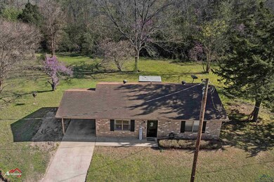 View of front of home featuring driveway, brick si