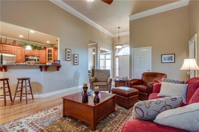 Large spacious great room with beautiful trim, stacked stone gas fireplace and hardwood.