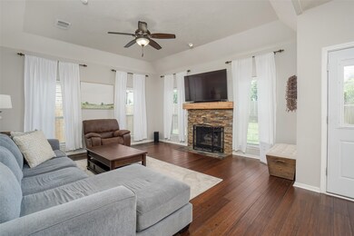 Living room surrounded by windows letting in a ton of natural light