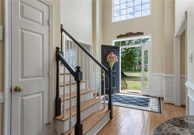 Natural light filled foyer/entry way with a high c