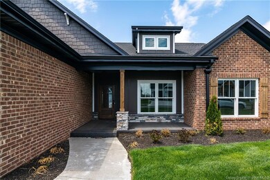 The covered entry offers space for seating and a w
