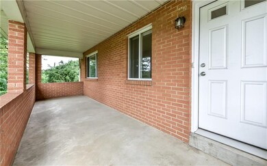 Nice sized front porch ready for your patio furnit