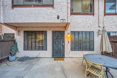 View of exterior entry featuring a patio, stucco s