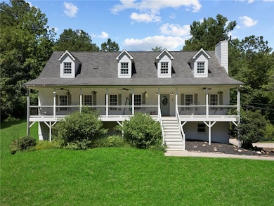 Cape cod-style house featuring ceiling fan, stairway, a front yard, and a porch