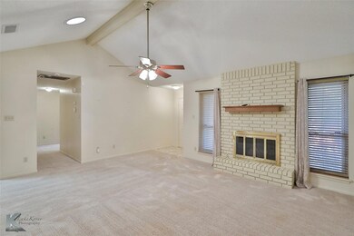 Unfurnished living room with ceiling fan, light co