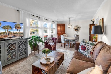 Living room with a textured ceiling, light hardwoo