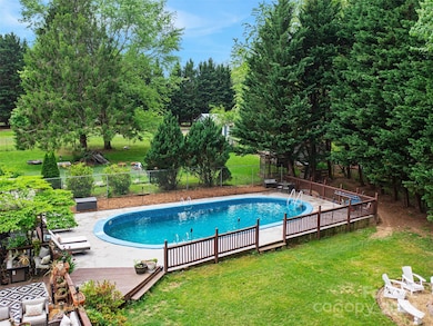 Swimming pool and fire pit in the completely enclosed backyard.