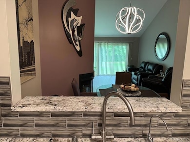Dining room featuring a chandelier and lofted ceiling