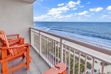 Balcony with a water view and a beach view
