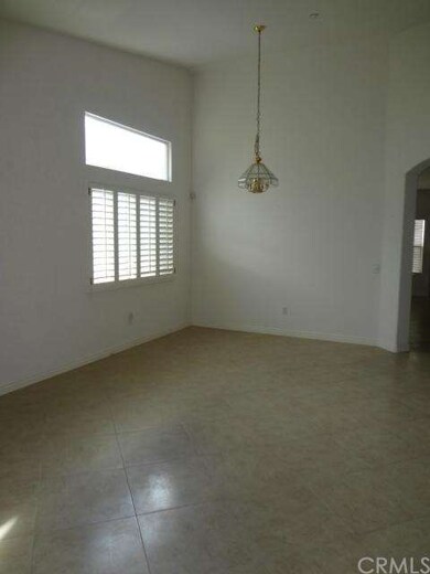 Living room and dining room with neutral tile, pla