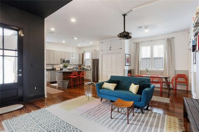 Living area into kitchen and dining area with exit