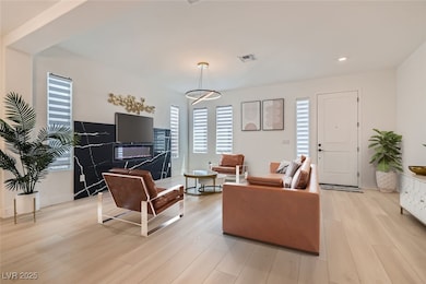 Living room featuring plenty of natural light, light wood-type flooring, and recessed lighting