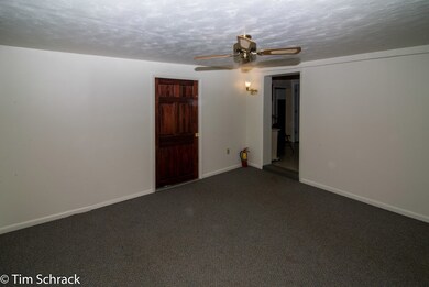 Living room showing doorways to Den and Kitchen