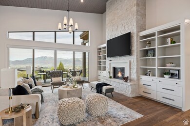 Living area featuring dark wood-style flooring, a high ceiling, a fireplace, a chandelier, and wood ceiling