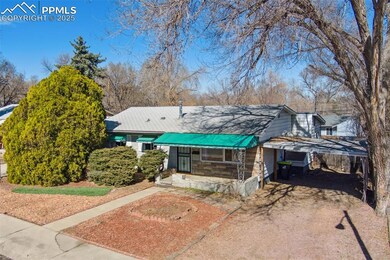 View of front of home with driveway, metal roof, a