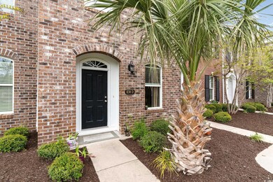 Entrance to property featuring brick siding