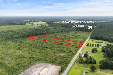 View of rural area with property parcel outlined and a forest