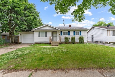 Single story home featuring board and batten siding, driveway, a chimney, and an attached garage