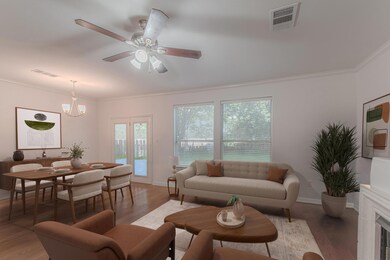 Living area with ornamental molding, ceiling fan,