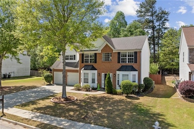 Colonial house featuring brick siding, driveway, f