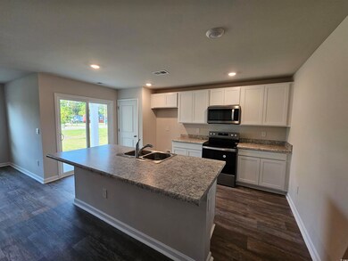 Kitchen with stainless steel microwave, range with