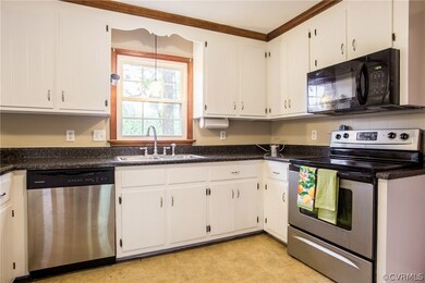 Kitchen includes laminate counter tops, stainless steel appliances and vinyl floor!