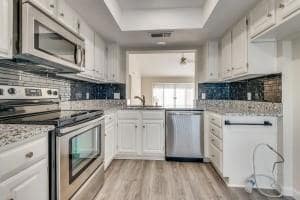 Kitchen featuring backsplash, light wood-style flo