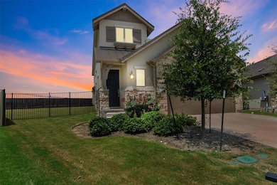 View of front of property with stone siding, driv