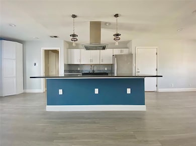 Kitchen featuring freestanding refrigerator, isla