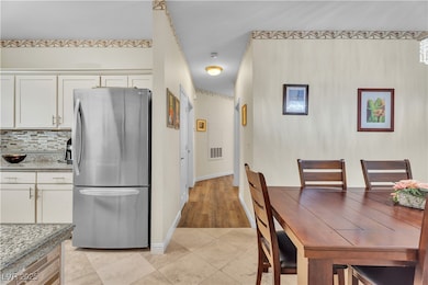 Dining area featuring light tile patterned floors and baseboards
