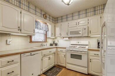 Open kitchen with gas stove and built-in mircowave