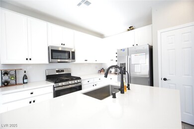 Kitchen with stainless steel appliances, white cab