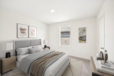 Carpeted bedroom featuring baseboards