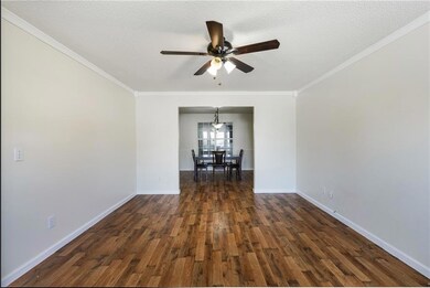 Spare room with ornamental molding, a ceiling fan,